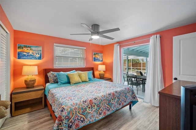 bedroom featuring access to exterior, a closet, a ceiling fan, and wood finished floors