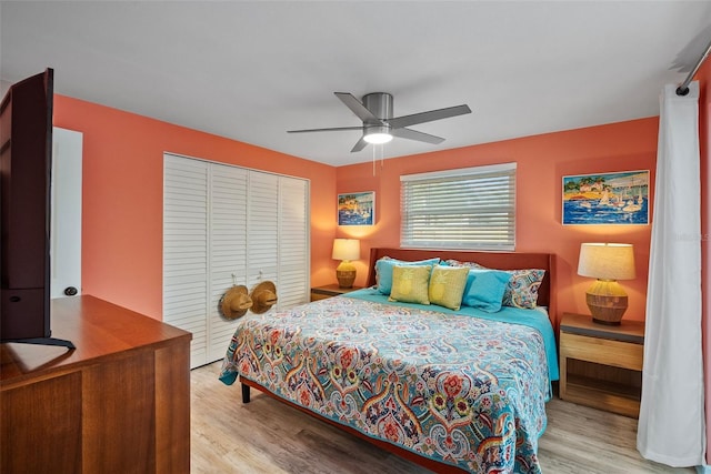 bedroom with a ceiling fan, a closet, and wood finished floors