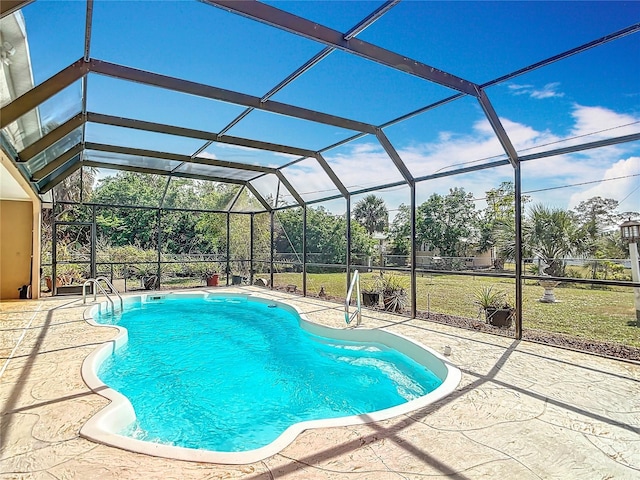 outdoor pool featuring a lawn, a patio area, and a lanai