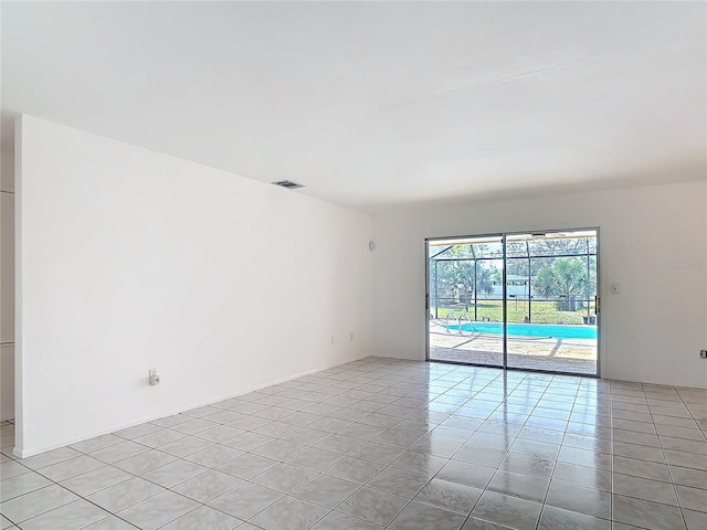 unfurnished room with light tile patterned floors and visible vents