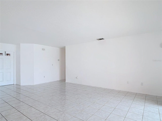 spare room with light tile patterned flooring and visible vents