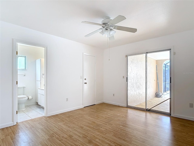 unfurnished bedroom with light wood-style floors, ensuite bath, and baseboards