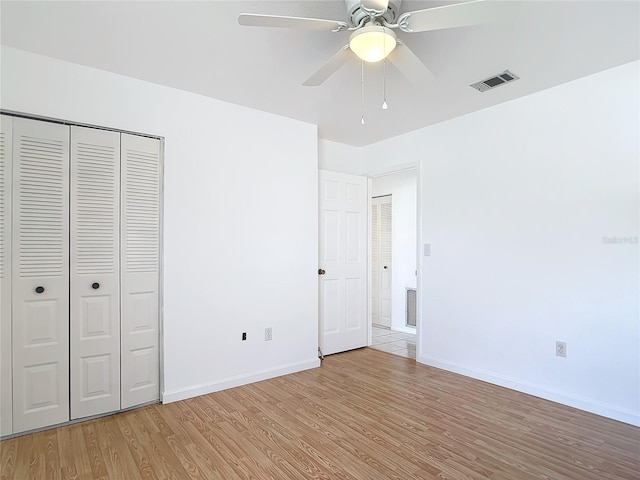 unfurnished bedroom with baseboards, visible vents, and light wood finished floors