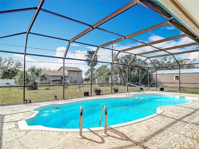 pool with a lawn, a patio area, and a lanai