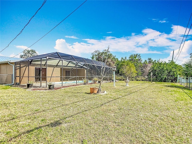 view of yard featuring a lanai, an outdoor pool, and fence