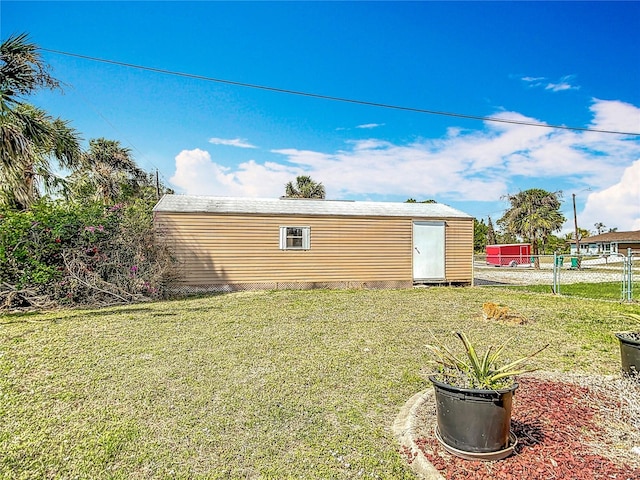 exterior space with a storage unit, an outdoor structure, and fence