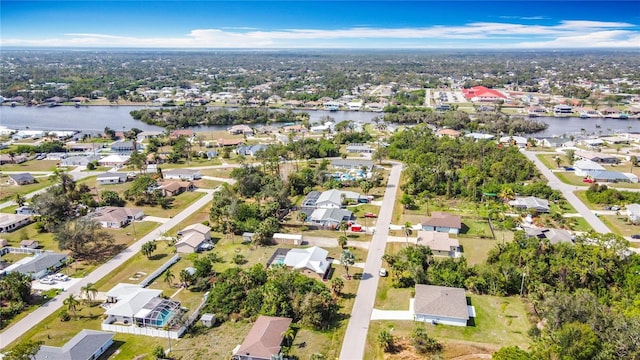 drone / aerial view featuring a water view and a residential view