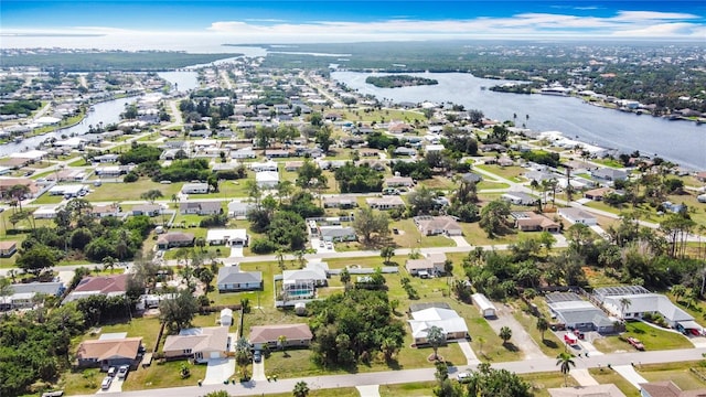 drone / aerial view featuring a residential view and a water view