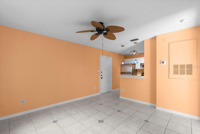 unfurnished room with a ceiling fan, baseboards, and light tile patterned floors