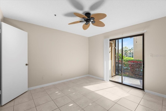 empty room featuring light tile patterned floors, ceiling fan, a textured ceiling, and baseboards