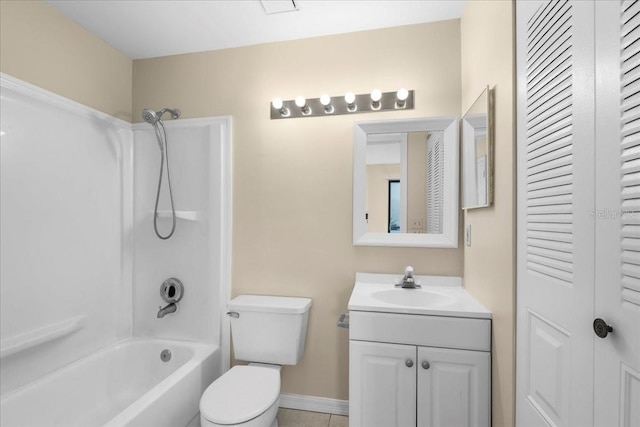 bathroom featuring a closet, toilet, vanity,  shower combination, and baseboards