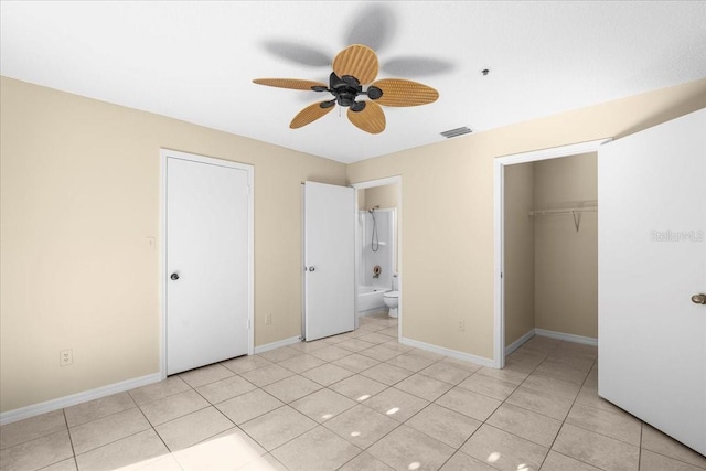 unfurnished bedroom featuring baseboards, visible vents, ensuite bath, a closet, and light tile patterned flooring