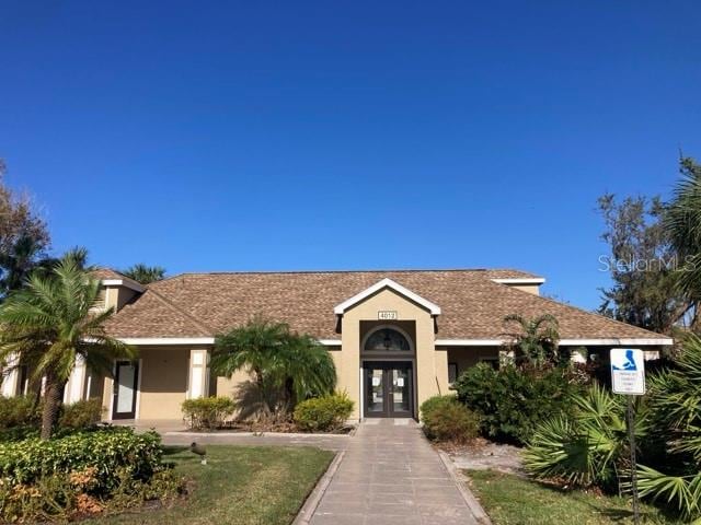 view of front facade featuring french doors and stucco siding