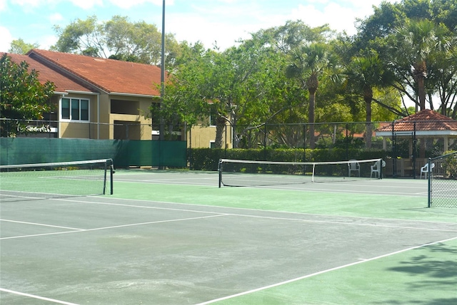 view of sport court featuring fence