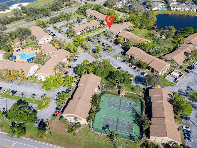 birds eye view of property with a water view and a residential view