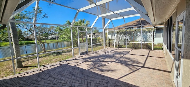 unfurnished sunroom featuring a water view