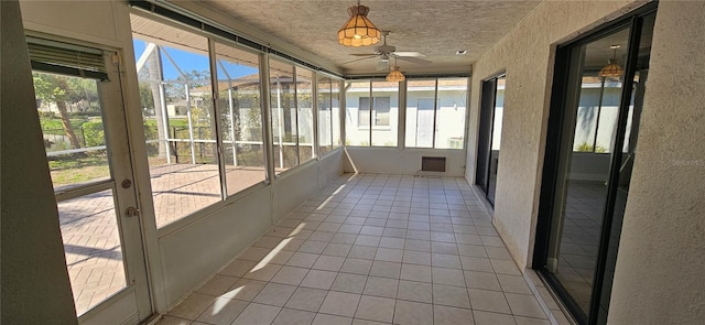 unfurnished sunroom with ceiling fan and a wealth of natural light