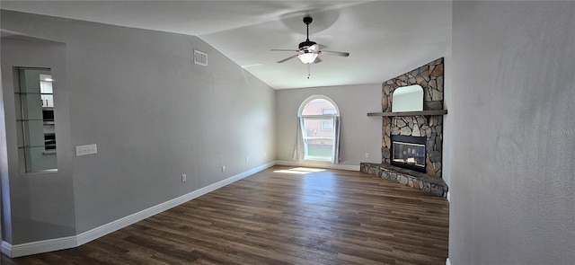 unfurnished living room with dark wood-style floors, a fireplace, visible vents, a ceiling fan, and vaulted ceiling