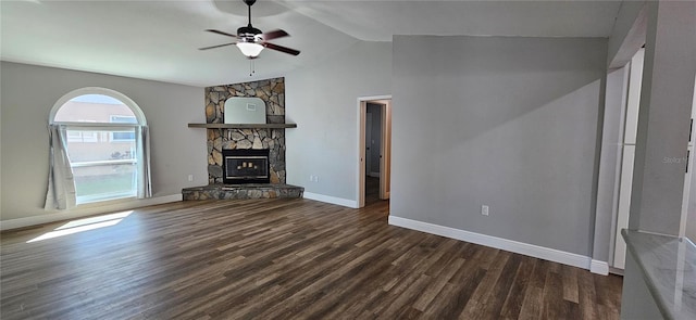 unfurnished living room with dark wood-style flooring, a fireplace, vaulted ceiling, ceiling fan, and baseboards