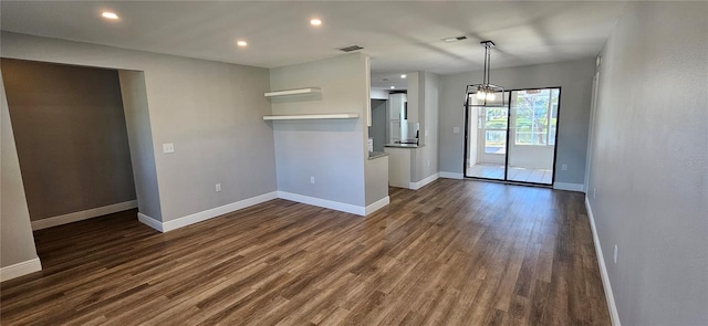 interior space featuring dark wood-type flooring, visible vents, and baseboards