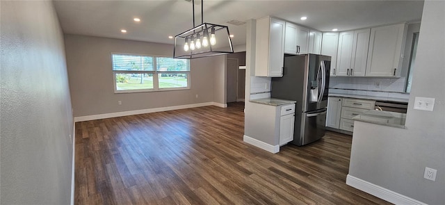 kitchen featuring white cabinetry, stainless steel refrigerator with ice dispenser, backsplash, dark wood finished floors, and pendant lighting