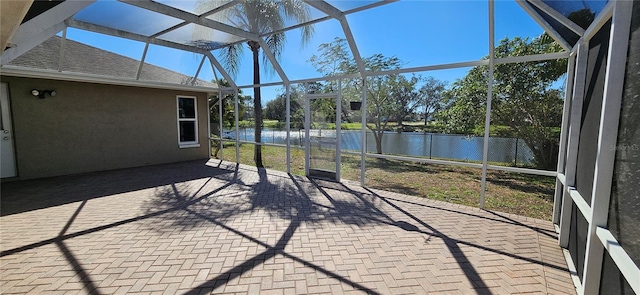 unfurnished sunroom with a water view