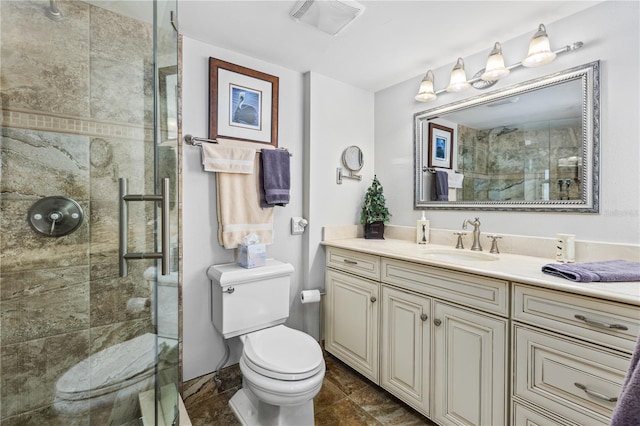 bathroom featuring visible vents, tiled shower, vanity, and toilet