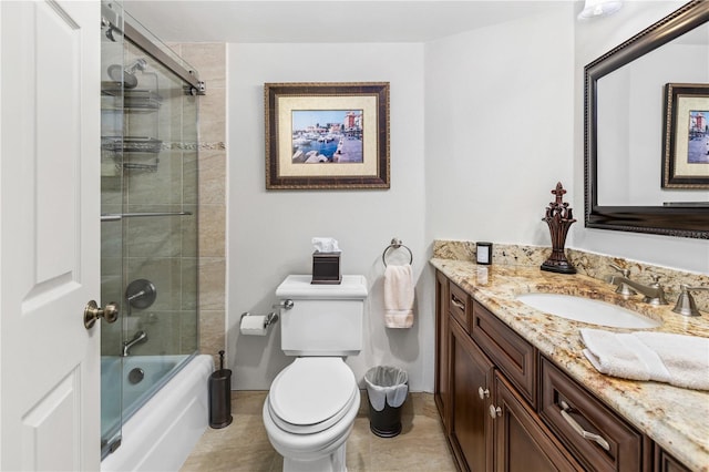 bathroom featuring toilet, enclosed tub / shower combo, and vanity