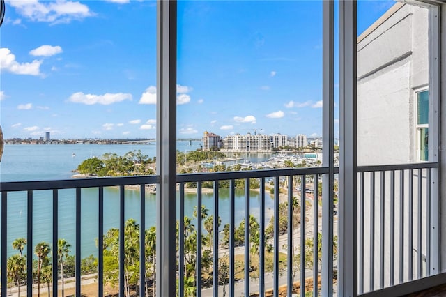 balcony featuring a water view and a city view