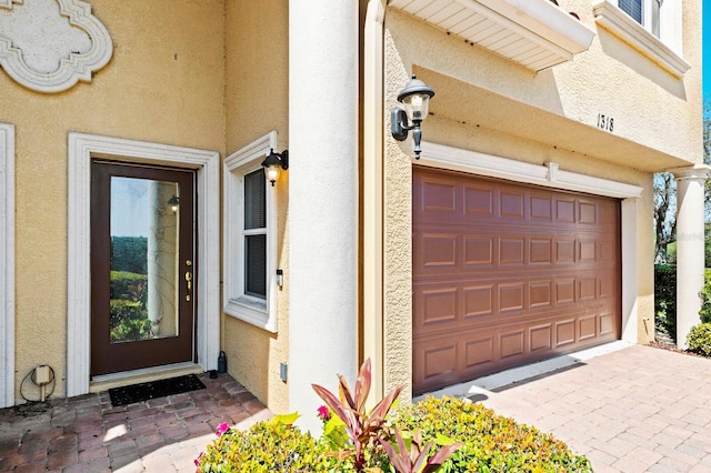 property entrance with stucco siding