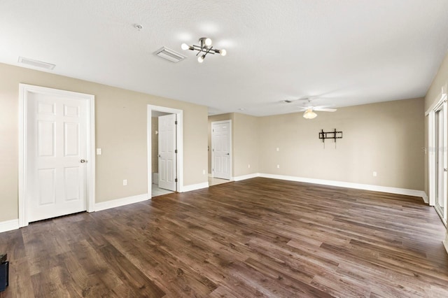 empty room featuring ceiling fan, baseboards, and wood finished floors