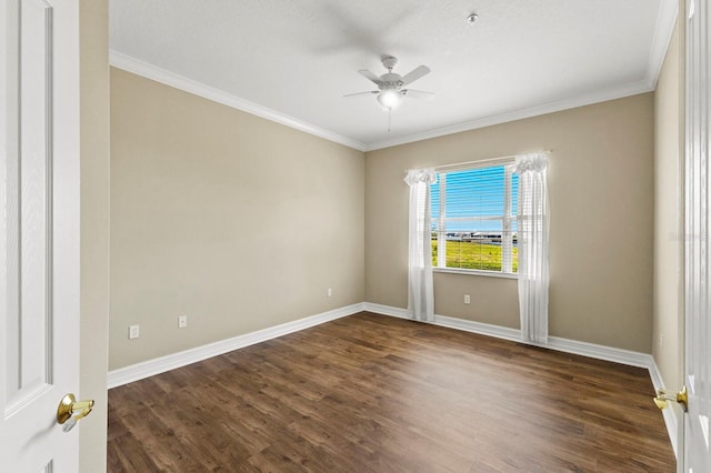 empty room with a ceiling fan, dark wood-style flooring, crown molding, and baseboards