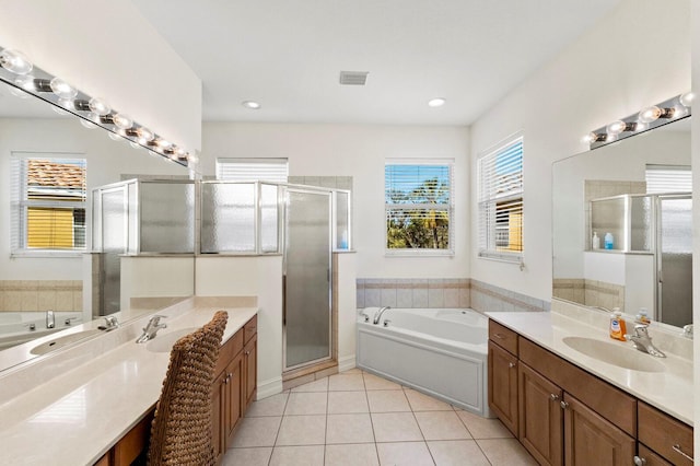 full bath with visible vents, a sink, tile patterned flooring, a shower stall, and two vanities