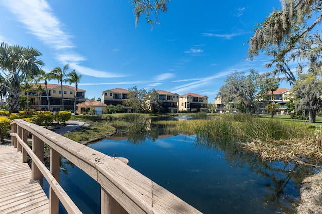 dock area featuring a residential view and a water view