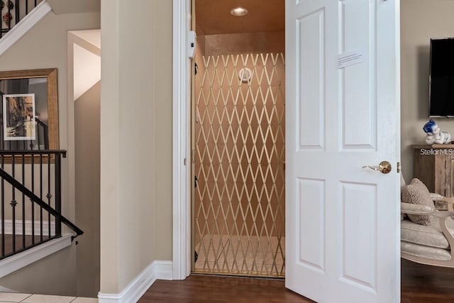 room details with baseboards and wood finished floors