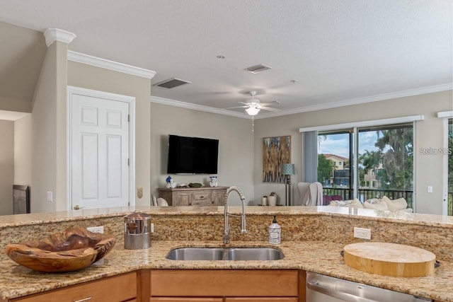 kitchen featuring dishwasher, light stone counters, a sink, and visible vents