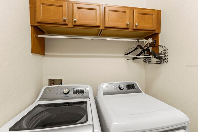 washroom featuring cabinet space and washer and dryer