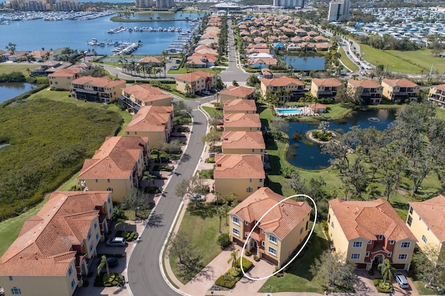 drone / aerial view featuring a water view and a residential view