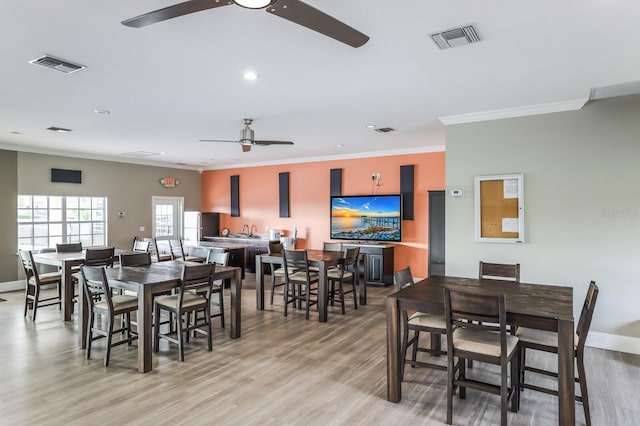 1318 3rd Street Cir E, Palmetto, FL 34221 - dining area featuring ceiling fan, crown molding, light wood-style flooring, and recessed lighting