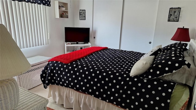 bedroom featuring a closet and light tile patterned floors