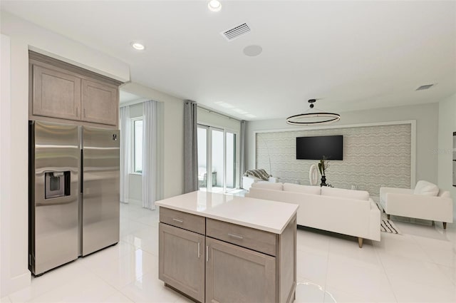 kitchen featuring visible vents, stainless steel fridge with ice dispenser, open floor plan, light countertops, and recessed lighting