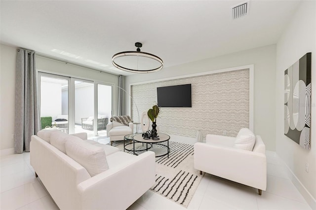 living room with visible vents, baseboards, and light tile patterned floors