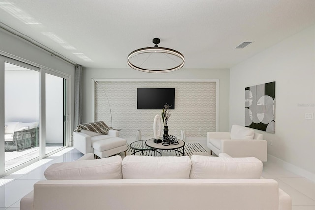 living area with visible vents, baseboards, and light tile patterned floors