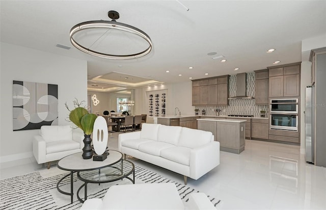 living area with recessed lighting, visible vents, baseboards, and light tile patterned flooring