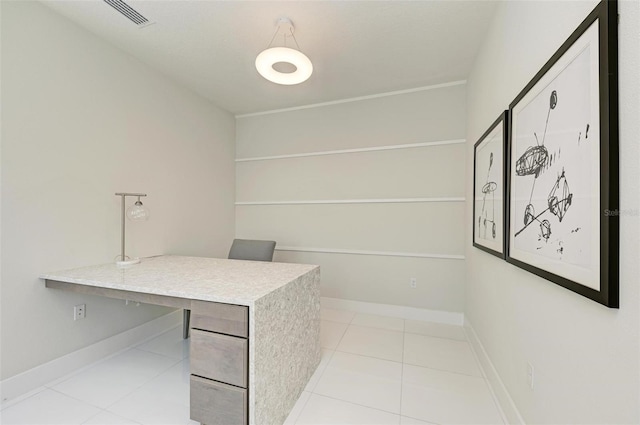 office area with light tile patterned flooring, visible vents, and baseboards