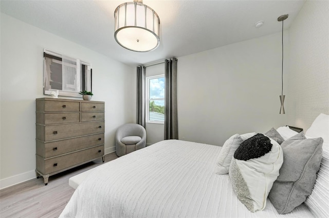 bedroom with light wood-style floors and baseboards