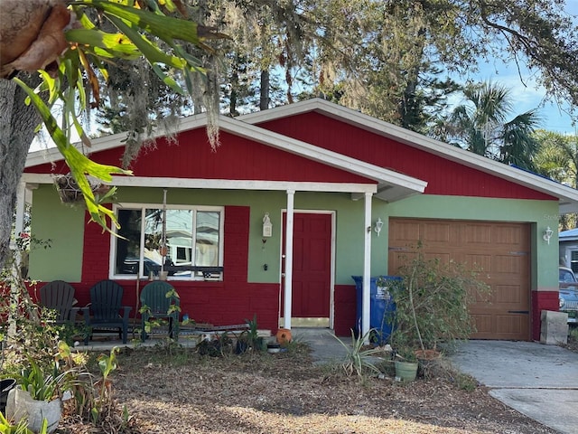 view of front of home with concrete driveway, brick siding, and an attached garage