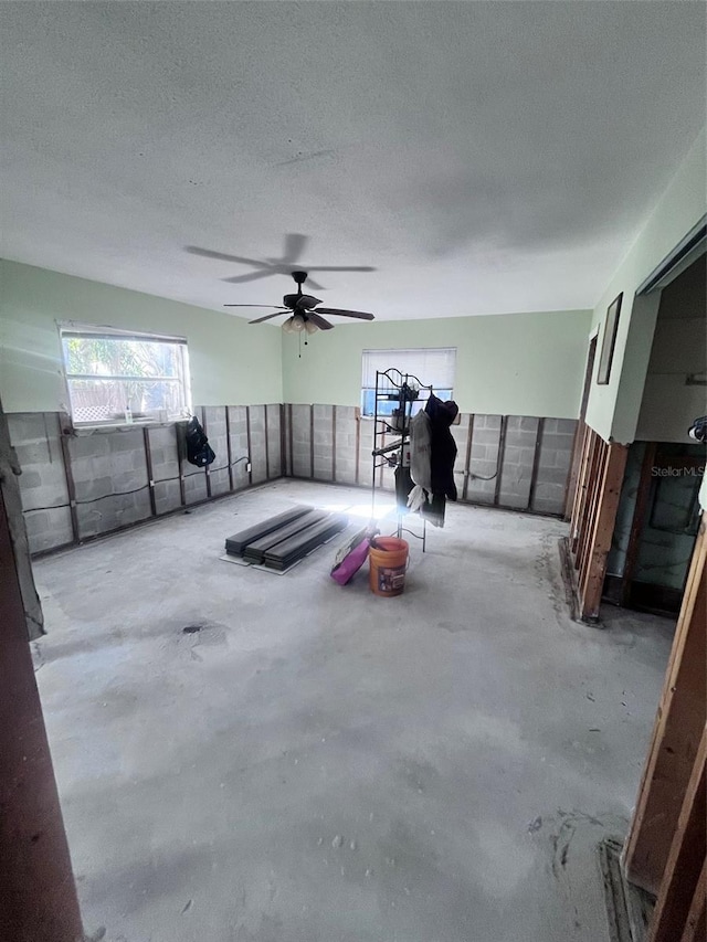 interior space featuring concrete floors and a textured ceiling