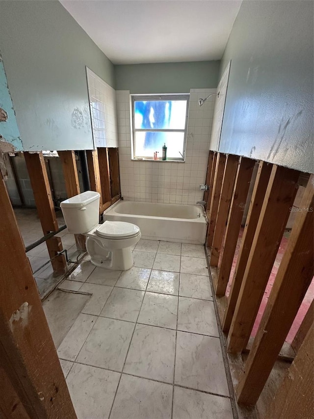 bathroom with toilet, tile patterned flooring, and bathtub / shower combination