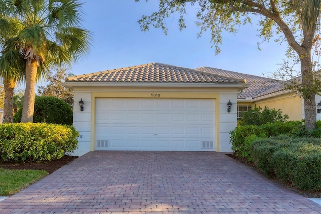 garage featuring decorative driveway